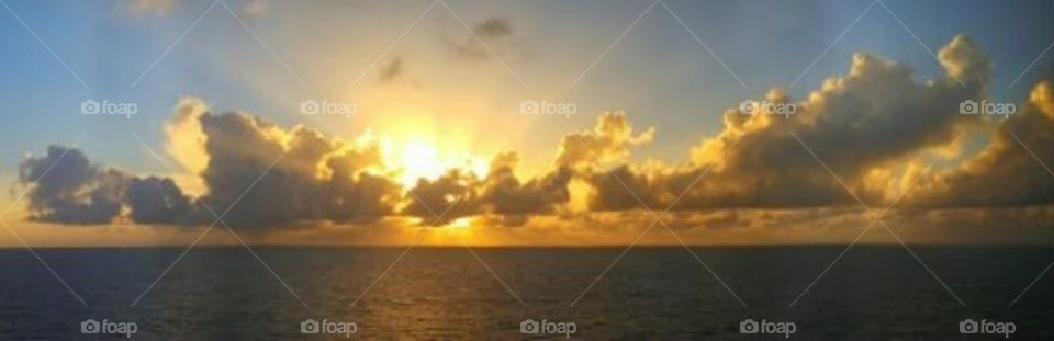 Beautiful sunset I captured, while cruising with family on the Atlantic Ocean. Motion, peaceful, clouds, water