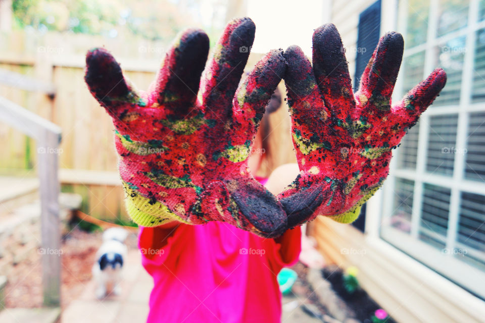 Little girl dirty garden gloves 