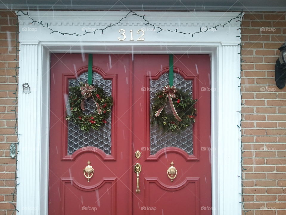 front doors. snowing and wreaths