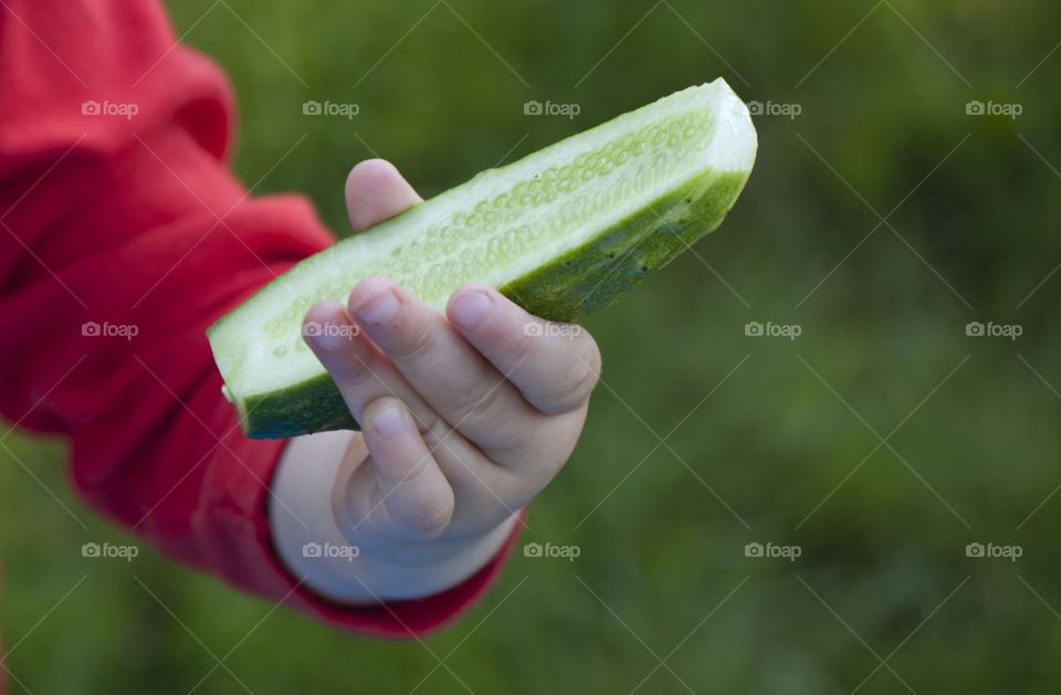 girl holding a cucumber