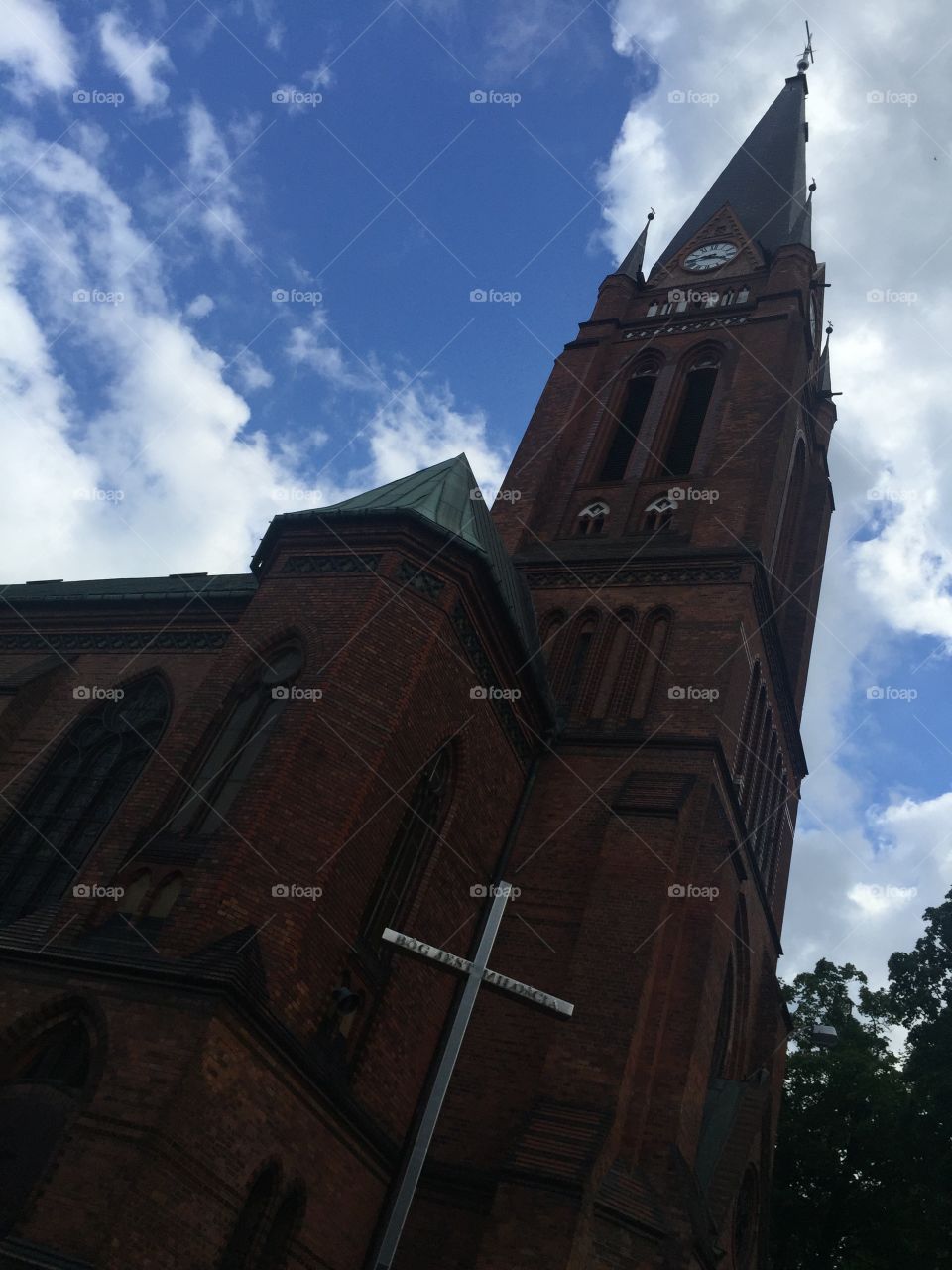 Facade of Roman Catholic church from
Side view and a crucifix 