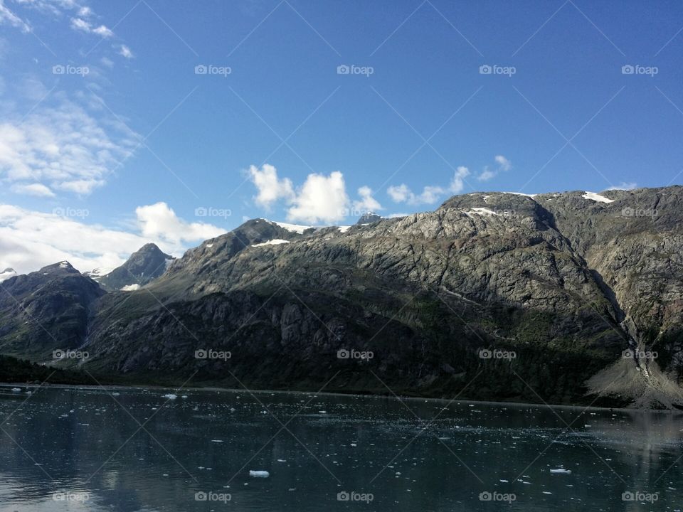 Glacier Bay National Park 
Breath taking mountains, clouds  and little glacier pieces floating in the water.
Alaska