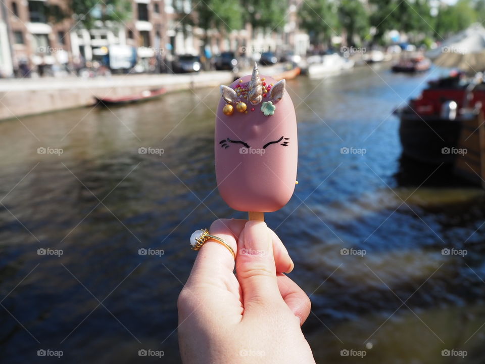 Unicorn cake popcicle next to the canal in Amsterdam