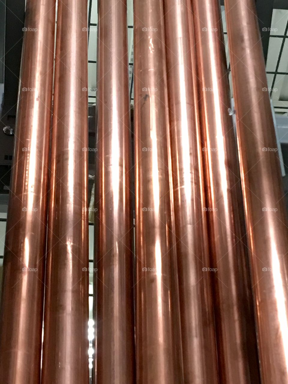 Copper pipes stacked up tall & shiny!