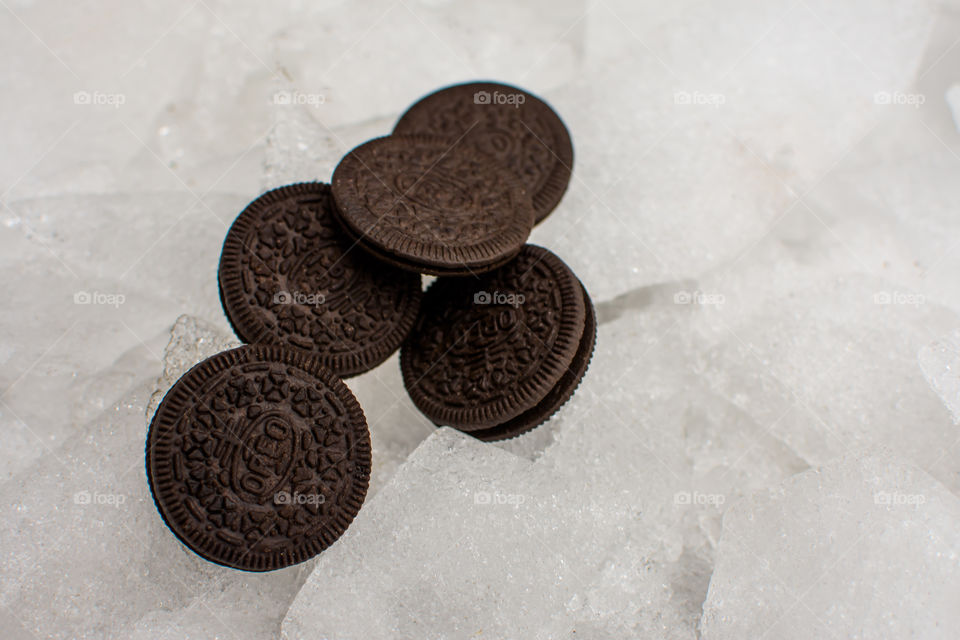 Cool Oreo Cookies artistic shot of Oreo Cookies on arctic terrain ice pieces and ice covered snow plies of fun Oreos travelling on winter background thin and thick Oreo Cookies art photography 