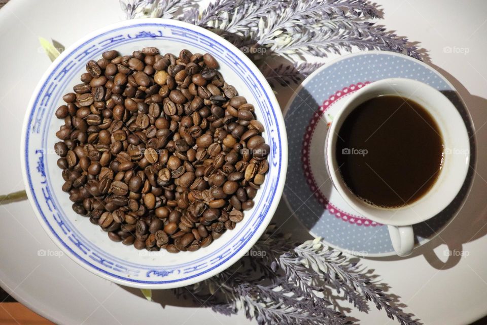 A cup of coffee and coffee beans