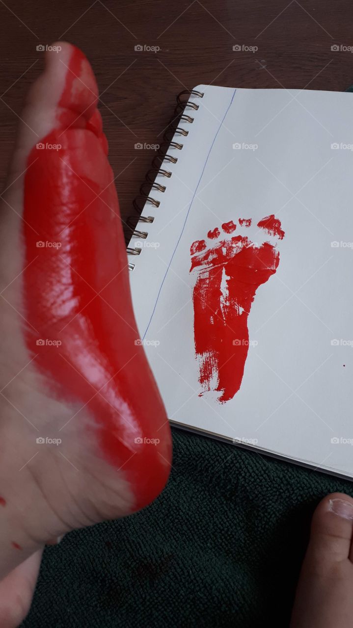 Red painted foot and footprint