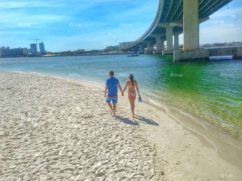 Couple walks on the beach