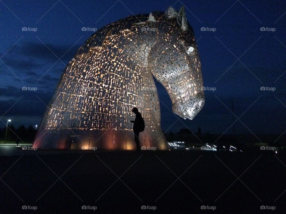 My son catching Pokemon figures at the Kelpies .. I love his silhouette against the light from the Kelpie names Duke ... 