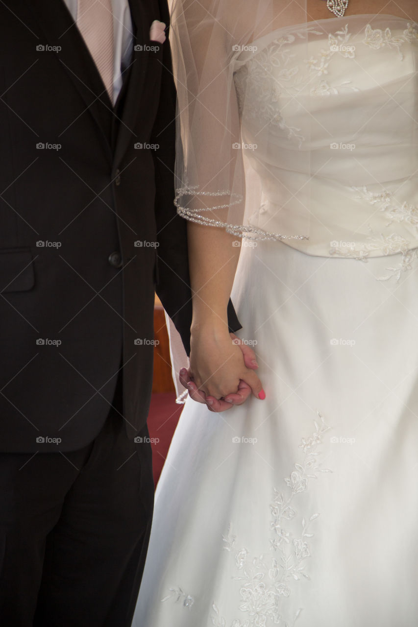 Bride and groom holding hands