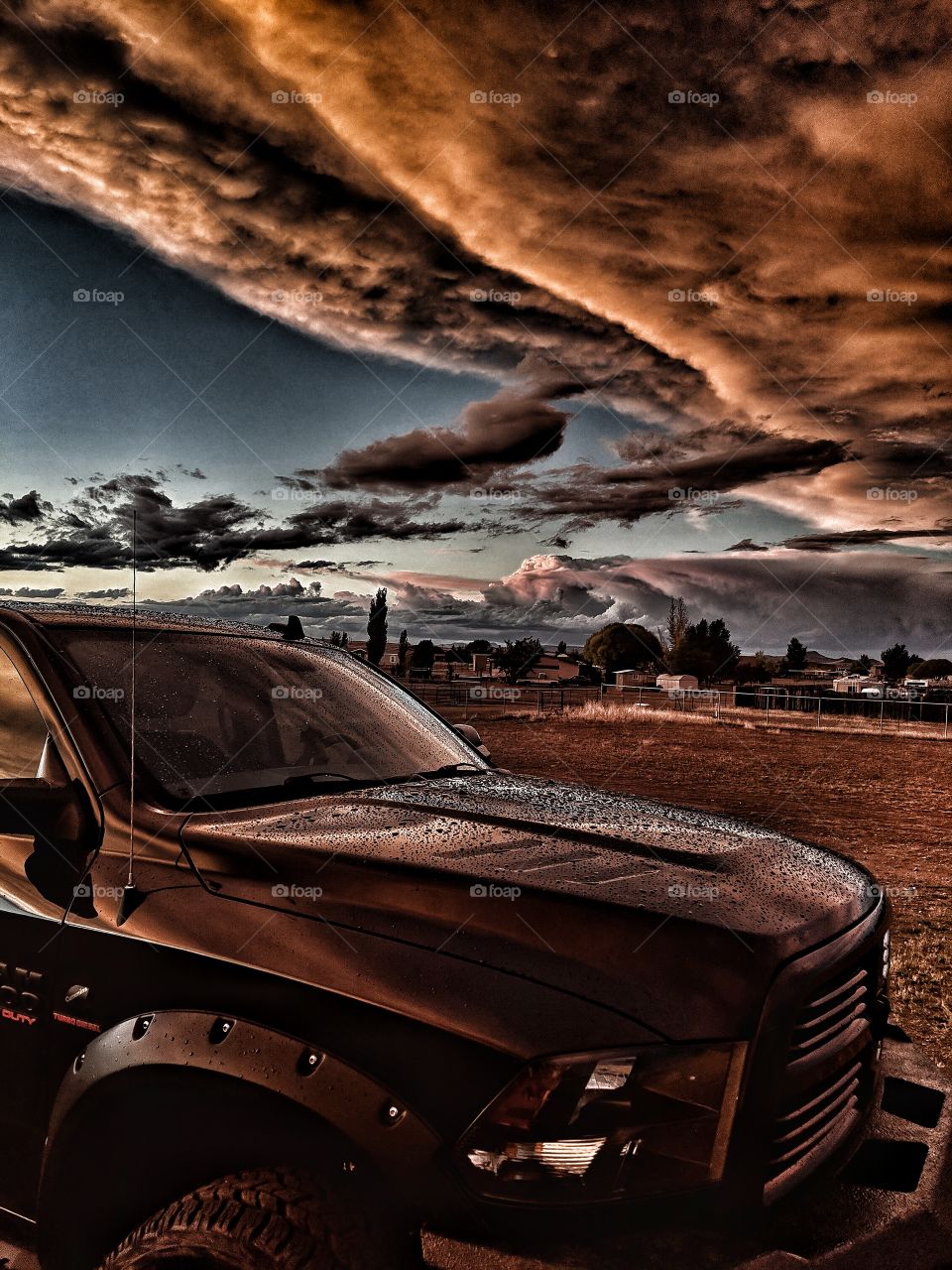 Truck after the storm under apocalyptic skies in the desert.