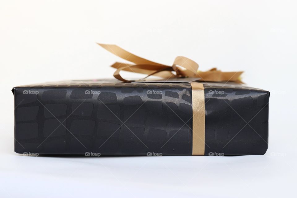 A black gift box with golden ribbon 