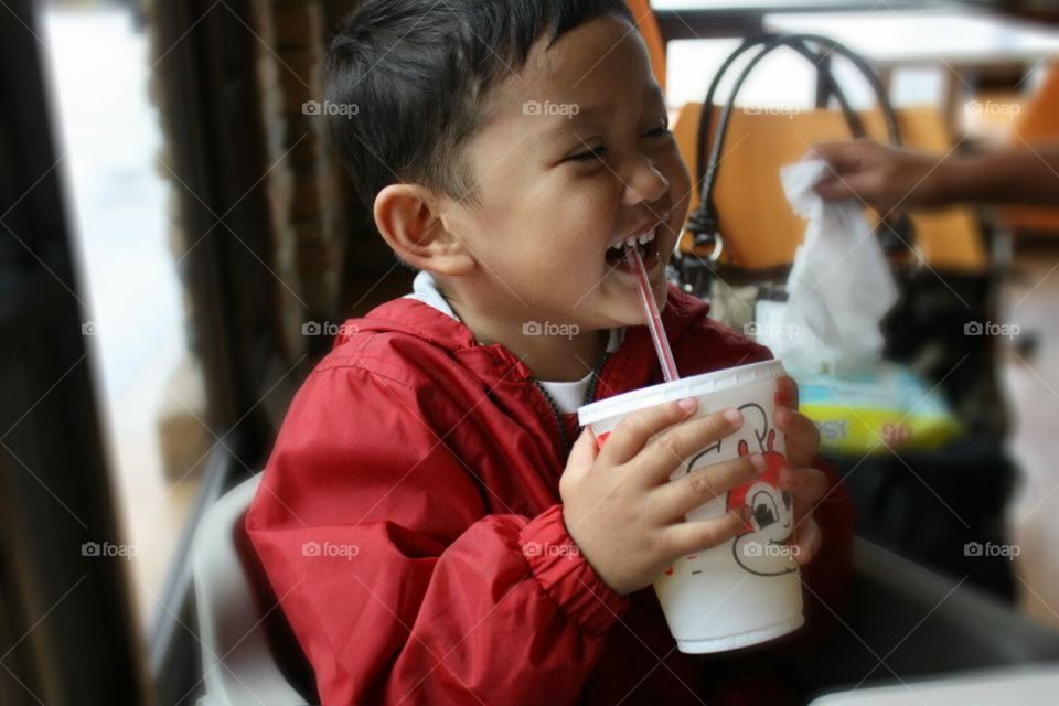 Zyrus. Nephew having fun and laughing while drinking