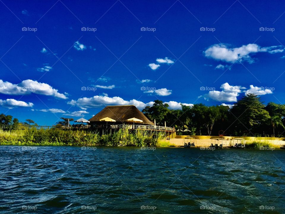 A view of the lodge from the boat on the water. Best time to be in the water, sunny, hot and blue. We cooling off.