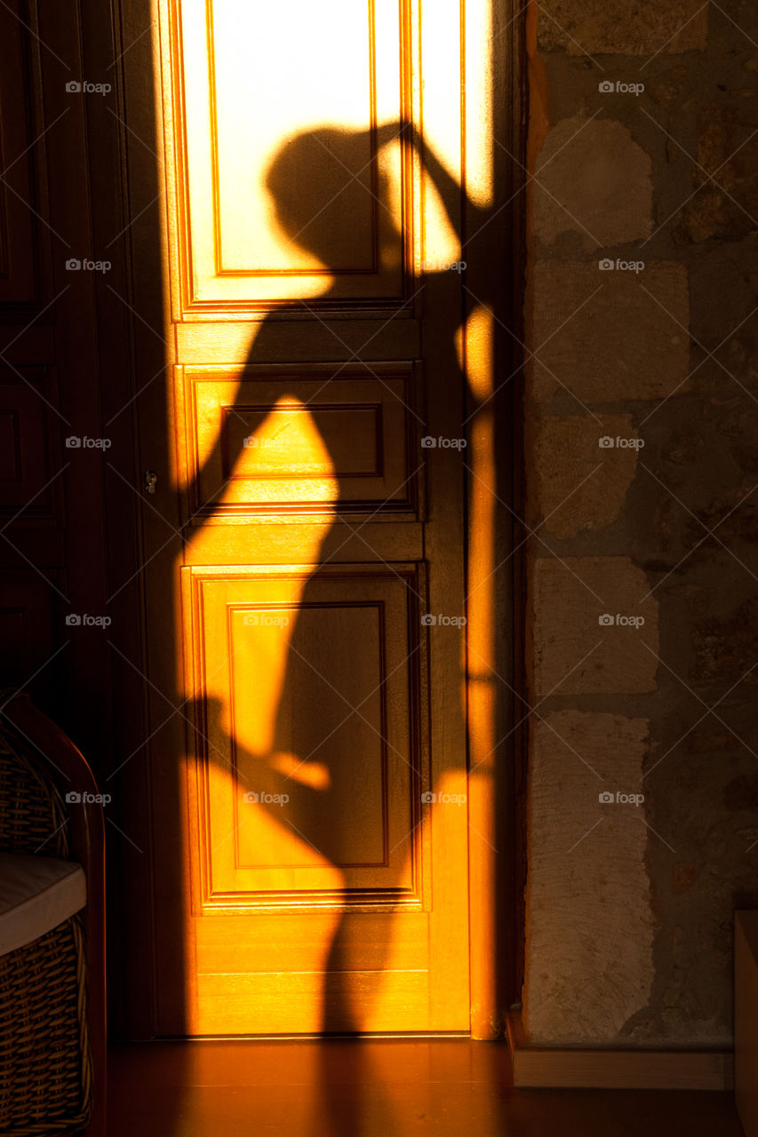 Woman’s shadow on the door 