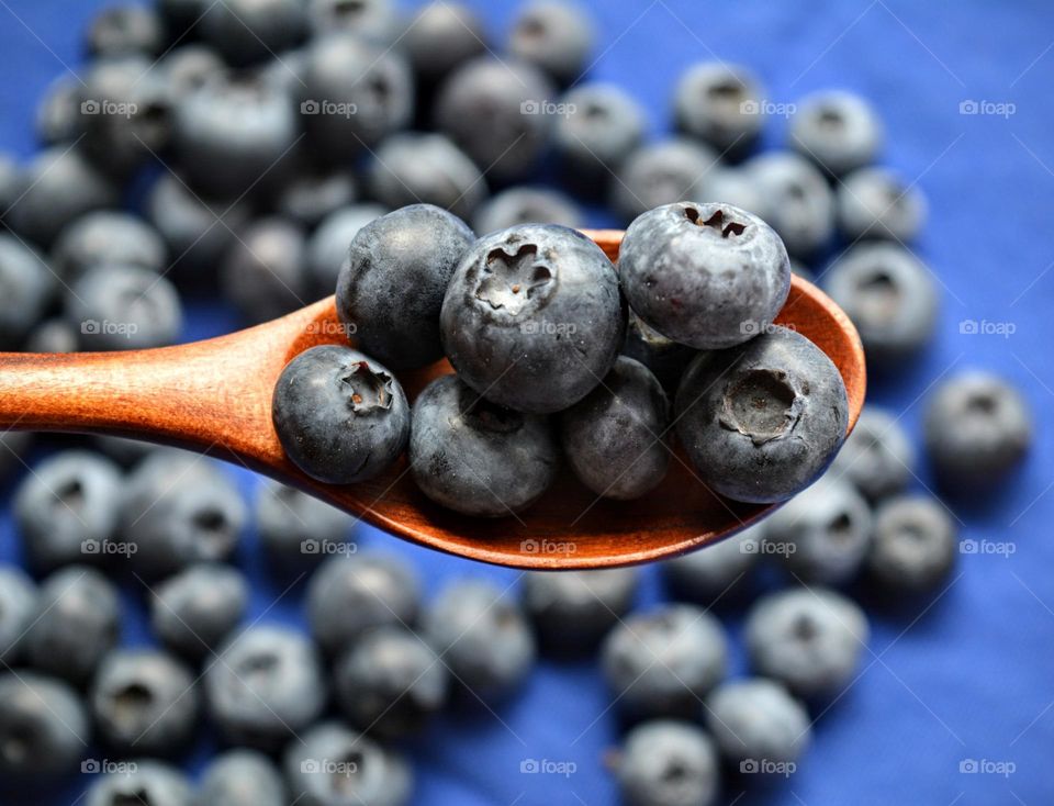 blueberries in wooden spoon