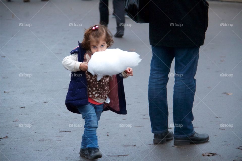 Cute girl eating candy floss