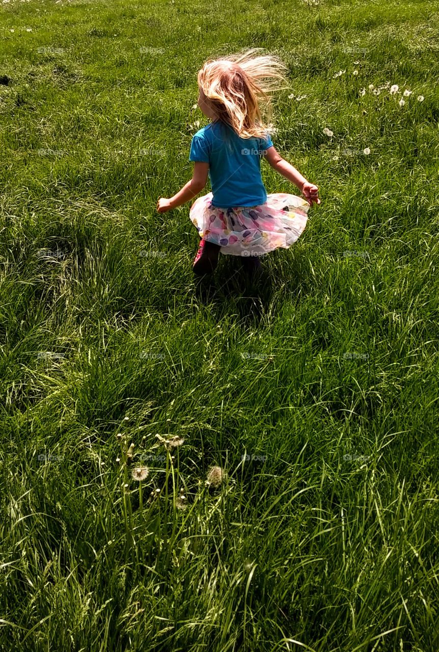 Little Girl Playing in a Field