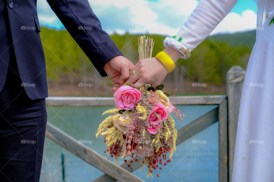 Groom and biride holding flowers