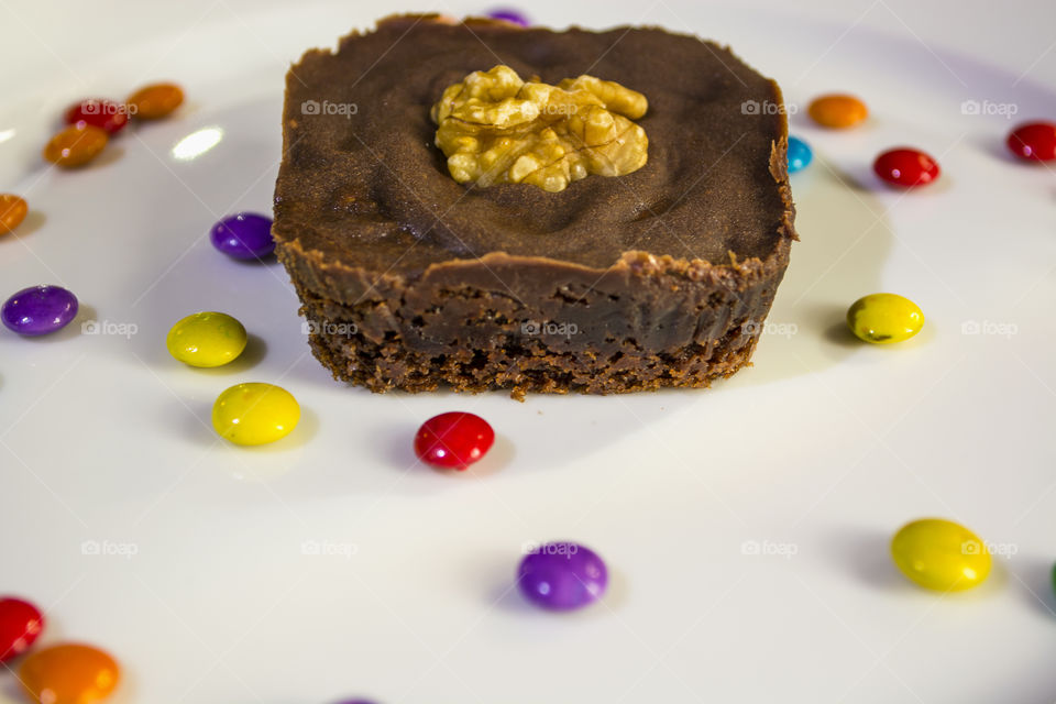 Delicious chocolate brownie and colorful candies