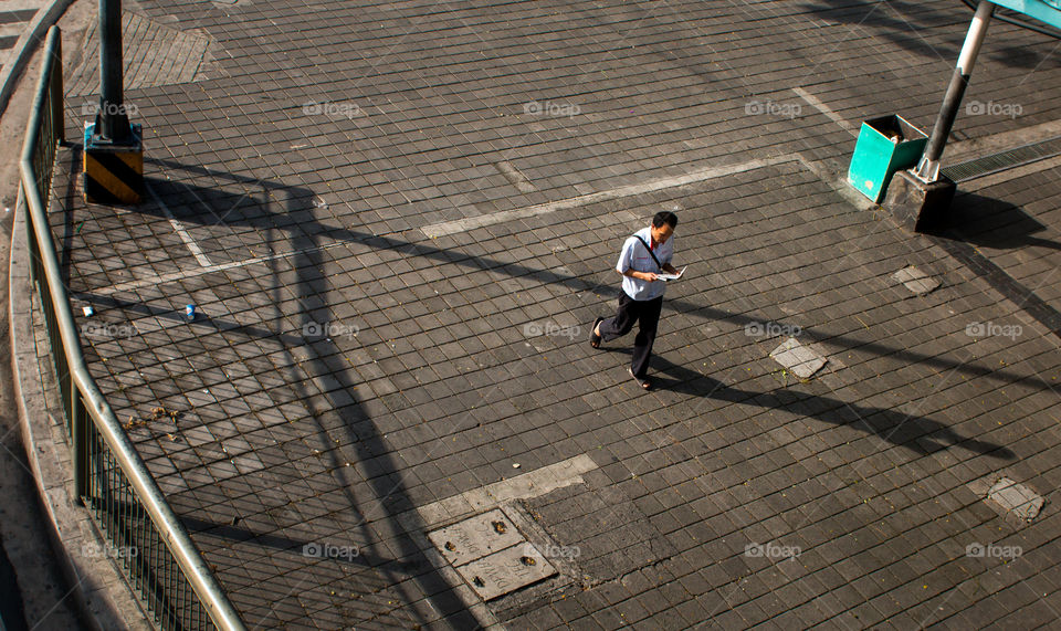 a commuter walking on a sidewalk