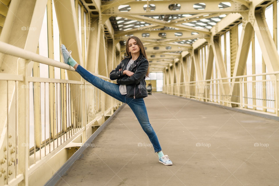 Girl is doing split in the city street