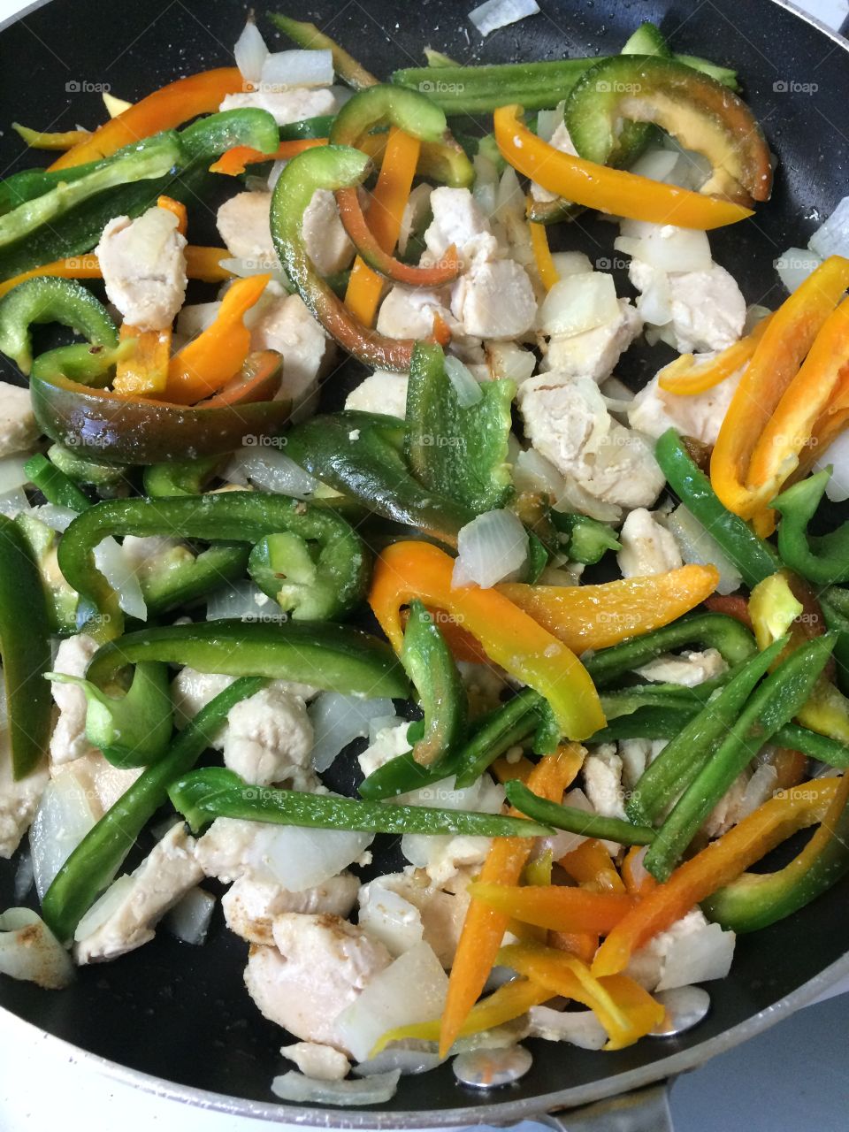 Homegrown peppers with onions and chicken.