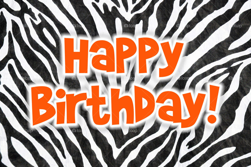Happy Birthday with a zebra pattern.