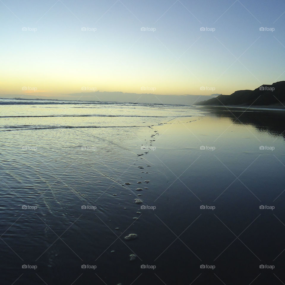 Bubbles on the shoreline at dusk