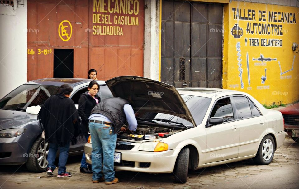 Auto mechanic fixing car in Guatemala 
