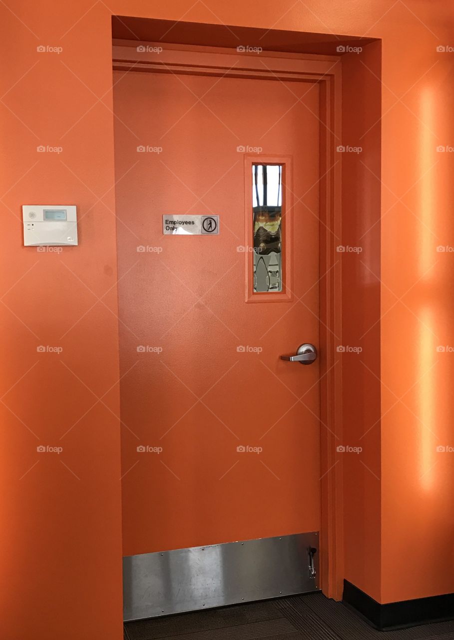 Orange door on an orange wall