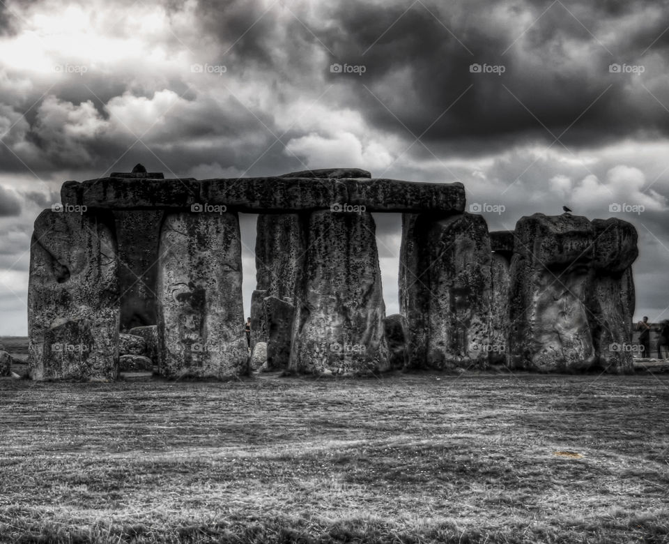 Black and white shot of stonehenge on a cloudy rainy summer day with shades of grey