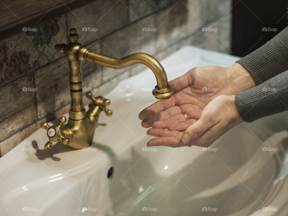 A person washing wash in sink