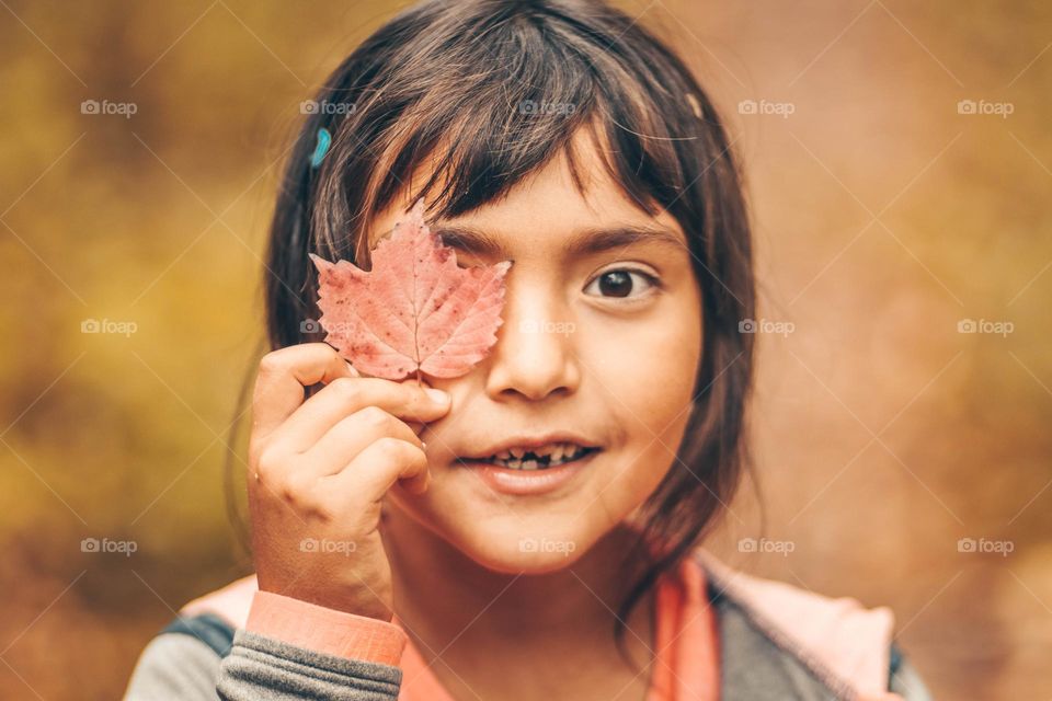 Girl with an autumn leaf