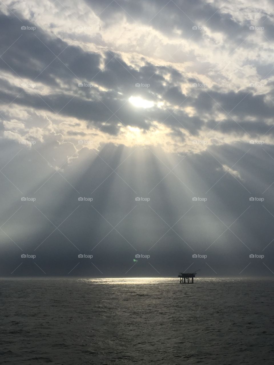 Sun breaking through the clouds over the Gulf 