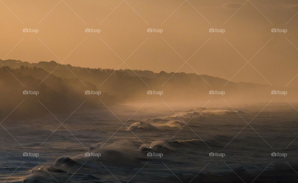 sea ​​waves with light fog plus warm sunrise
