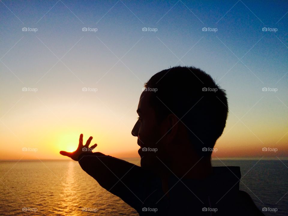 Enjoy sunset. Silhouette of a man having fun posing with sunset golden hour