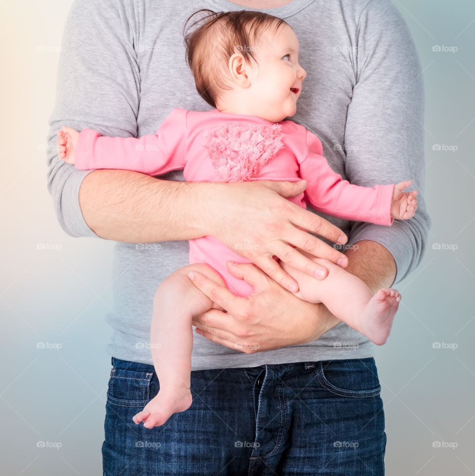Father holding his cute baby girl