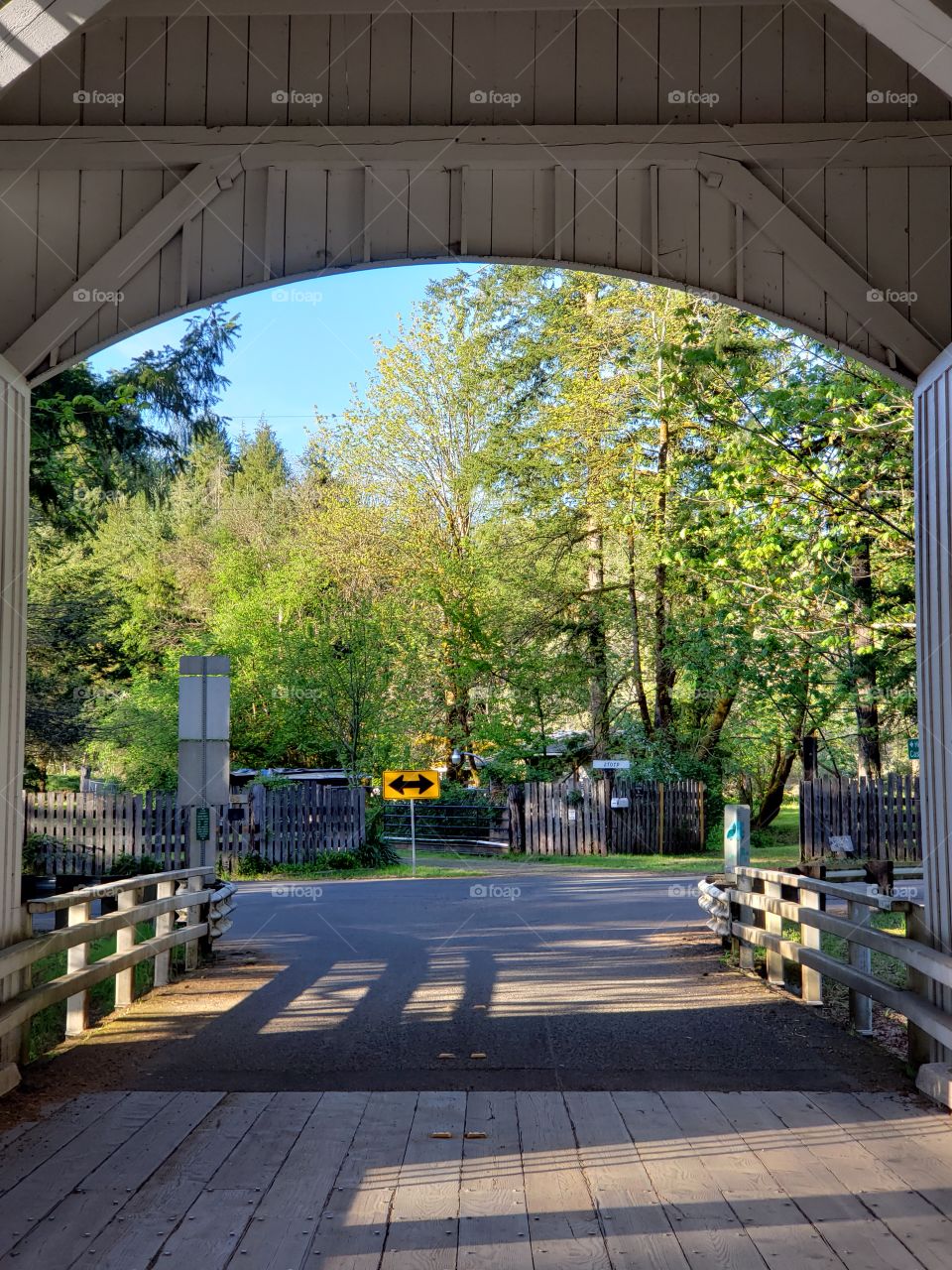 The view from inside a short covered bridge in Western Oregon on a sunny spring day. 