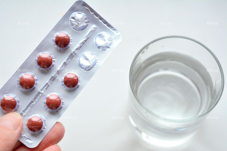 pills in hand and water glass round beautiful texture