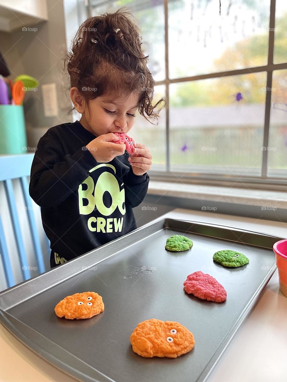 Little girl eats Halloween treats, making Monster Cookies with Mommy, sweet Halloween treats, baking at home for the Holidays, making Halloween Cookies, baking with toddlers 