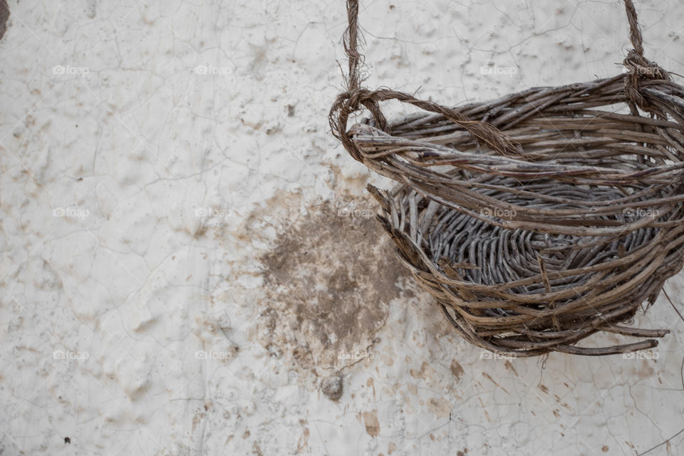 Wicker basket on a white wall.
