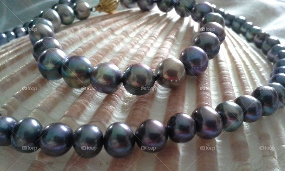 black pearl bracelet necklace on shell