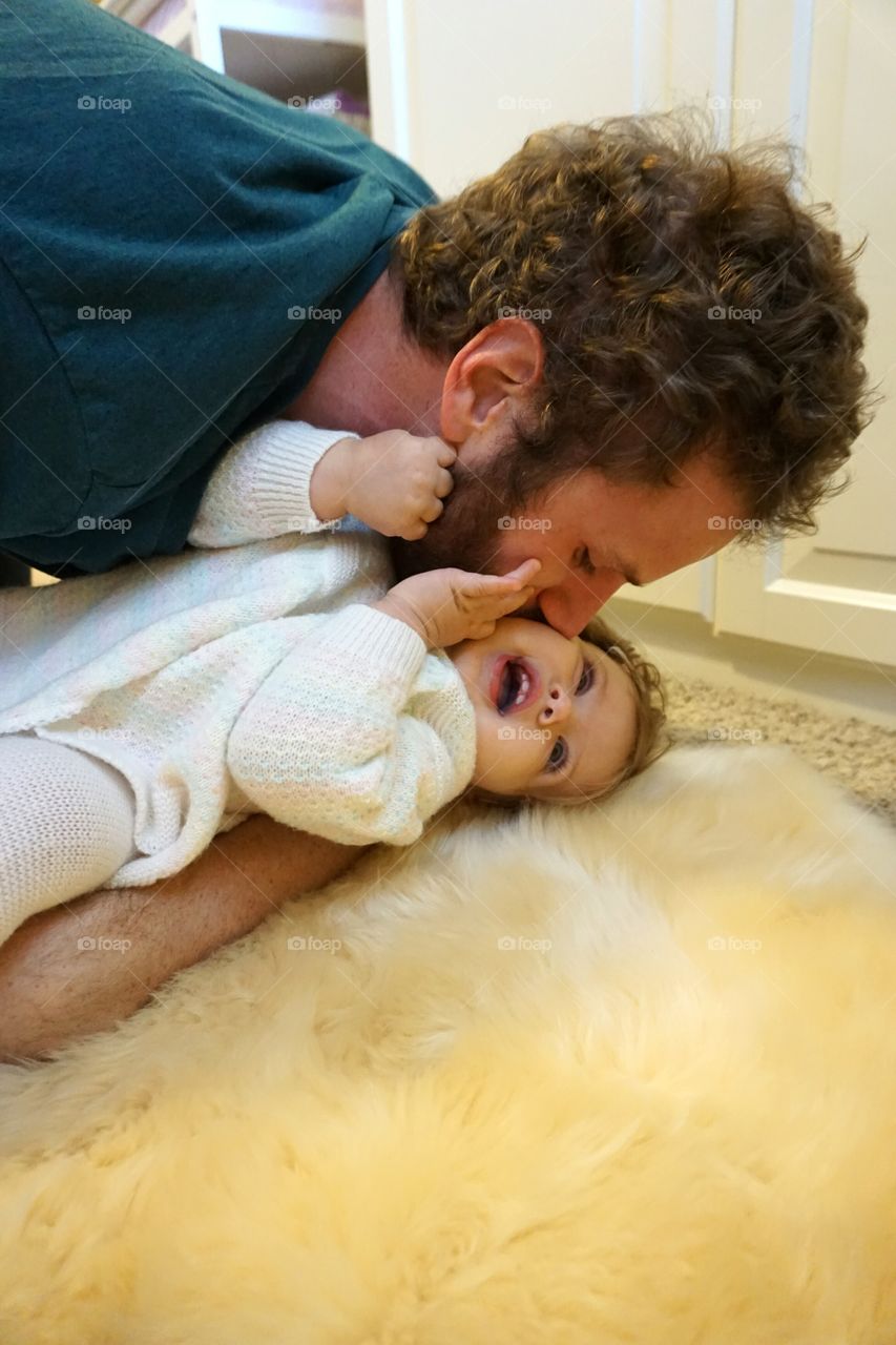 Father kissing cute daughter