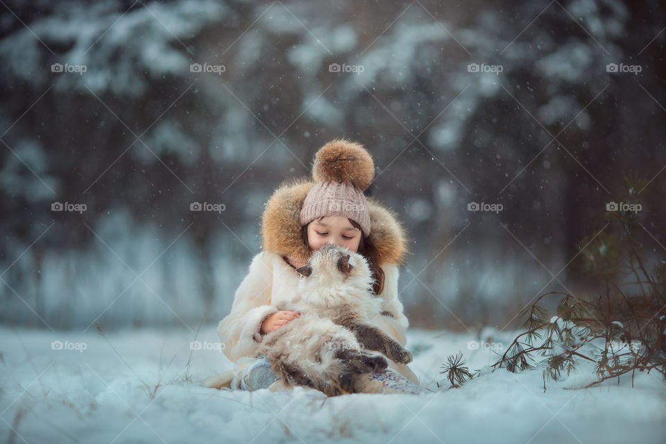 Little girl portrait with cat, winter outdoor 