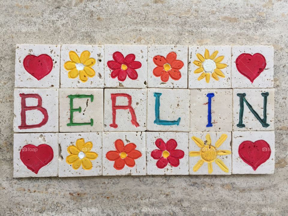 Berlin, souvenir with flowers and red hearts on carved travertine pieces