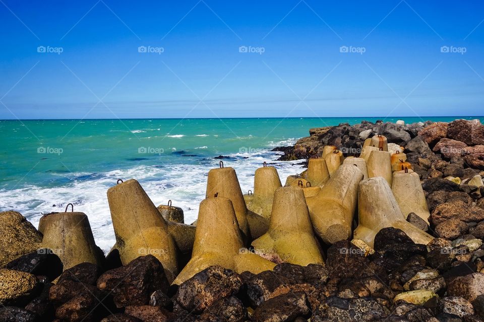 Dolos and beautiful sea green water at the Oamaru Breakwater, New Zealand 