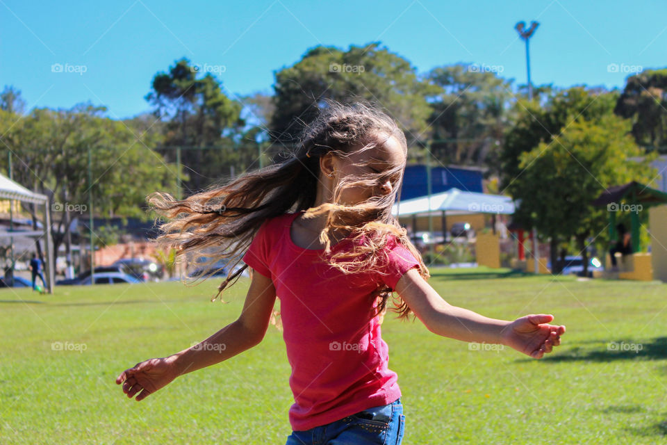 little girl running in the park