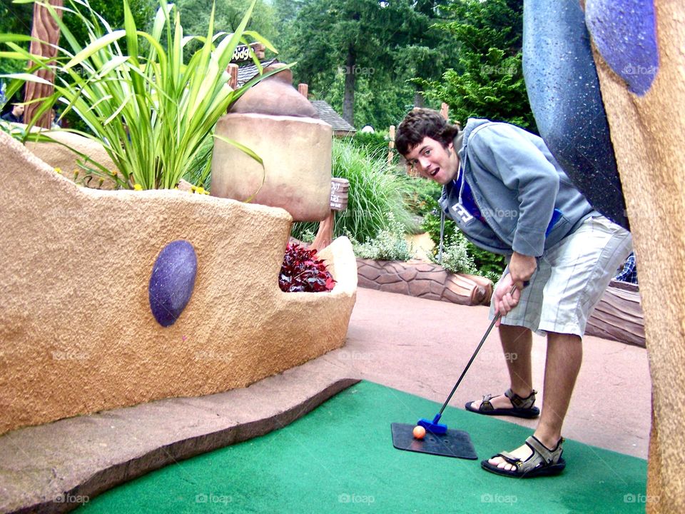 Playing mini golf 