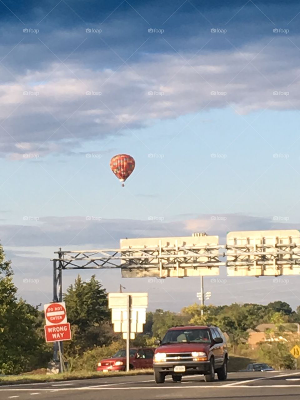 Riding home from work, in the middle of a big intersection, floated a beautiful hot air balloon.